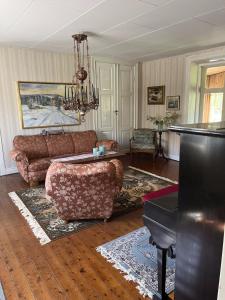 a living room with a couch and a table at Starby bondgård in Ängelholm