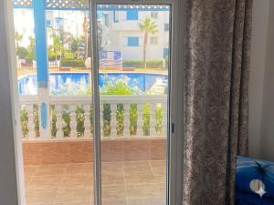 a sliding glass door with a view of a pool at Luxury apartment Smir Park - Marina Smir in Marina Smir