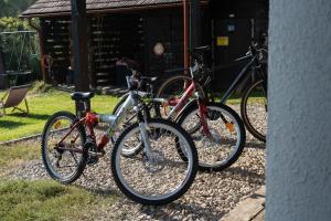 three bikes parked in front of a building at Agroturystyka Ropienka in Ropienka