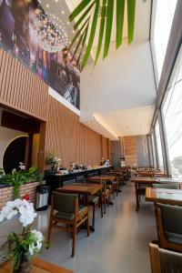 a dining room with wooden tables and chairs at Airport Hotel Gru in Guarulhos