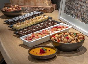 a table topped with trays of different types of food at Hotel Geysir in Geysir