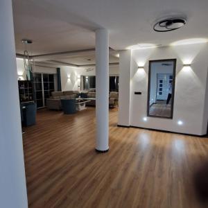a living room with a large mirror on the wall at Villa Breza in Bihać