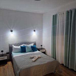 a bedroom with a bed with two towels on it at Villa Breza in Bihać