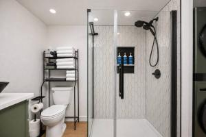 a bathroom with a shower and a toilet at Cozy Coastal Cabin in Rockaway Beach +23 photos