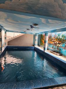 an indoor swimming pool with a canopy over the water at RÉSIDENCE MAME DIARRA kl in Kaolack