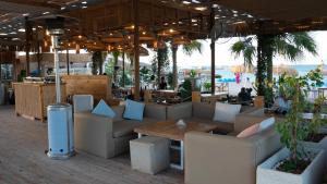 a restaurant with couches and tables and a beach at Selena Bay Hotel Suites in Hurghada