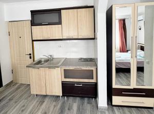 a small kitchen with a sink and a bed at Готель-Ресторан Соната in Sambir
