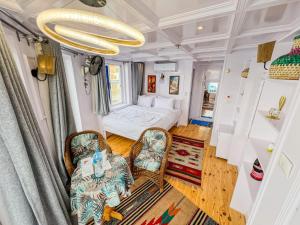 a room with a bed and a couch and chairs at Youssef Nile Boat in Luxor
