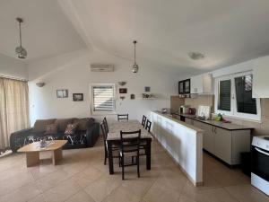 a kitchen and living room with a table and a couch at Beachside 2-Bed Bliss! in Blace