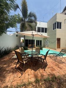 a patio with a table and chairs and a pool at Pool, Space, Style, Modern House for 8 in Brisas de Zicatela