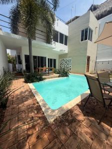 a swimming pool in front of a house at Pool, Space, Style, Modern House for 8 in Brisas de Zicatela