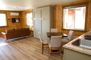 a kitchen and dining room with a table and chairs at Shell Campground in Shell