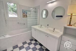 a bathroom with two sinks and a tub and a mirror at Mathilde in Lannion +31 photos