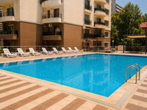 a large swimming pool in front of a building at Dream Catchers LOFT in Bucharest