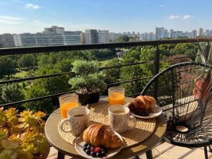 a table with croissants and coffee cups on a balcony at Dream Catchers LOFT in Bucharest
