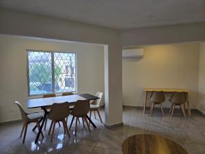 a dining room with a table and chairs and a window at Cumbre Guesthouse in Monterrey