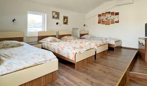 a room with three beds in it at Готель-Ресторан Соната in Sambir