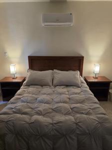 a bedroom with a large bed with two night stands at Cumbre Guesthouse in Monterrey