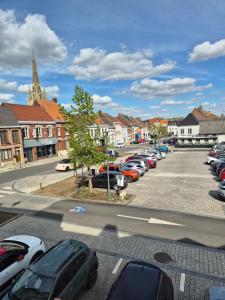 a parking lot with cars parked in a town at O centre in Steenvoorde