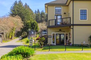 a large yellow house with a garage on a street at Camp Trinidad RV Resort in Trinidad