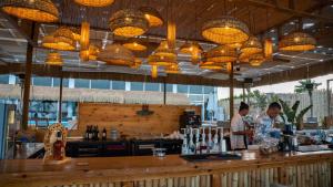two people standing at a bar in a restaurant at Selena Bay Beach Resort in Hurghada