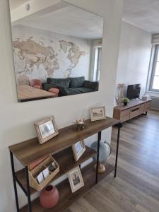 a living room with a table and a map on the wall at O centre in Steenvoorde