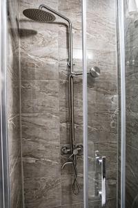 a shower with a glass door in a bathroom at Готель-Ресторан Соната in Sambir