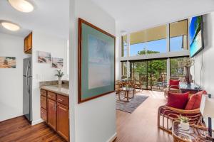 a kitchen and living room with a large window at Makani A Kai B11 in Wailuku