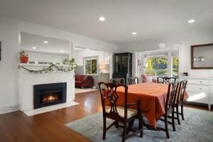 a dining room with a table and a fireplace at Yellow York House in Bellingham