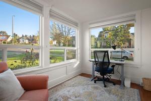 a home office with a desk and two windows at Yellow York House in Bellingham