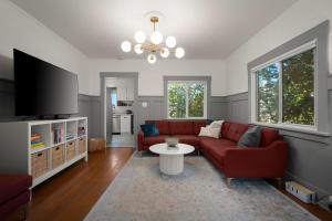 a living room with a red couch and a table at Yellow York House in Bellingham