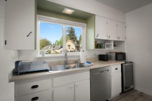 a kitchen with a sink and a window at Yellow York House in Bellingham