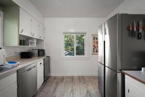 a kitchen with a stainless steel refrigerator and a window at Yellow York House in Bellingham +46 photos