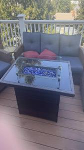 a coffee table on a deck with a blue couch at Maggie S Place in Salem