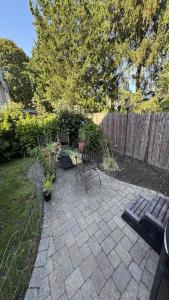 a patio with two benches and a table and chairs at Maggie S Place in Salem
