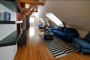 a living room with blue couches and a rug at Historic Haven in Riga