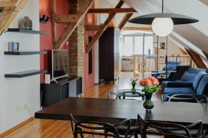 a dining room and living room with a table and chairs at Historic Haven in Riga +11 photos