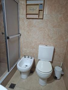 a bathroom with a toilet and a shower at Sol y Luna Hospedaje in Monte Grande +18 photos