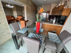 a dining room with a glass table and chairs at Sudresidence in Agadir