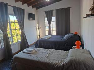 a bedroom with two beds and a window at Sol y Luna Hospedaje in Monte Grande