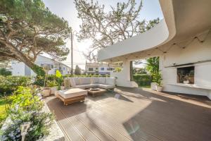 an outdoor patio with a couch and a fireplace at Сasa do Cedro in Colares