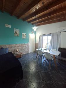 a bedroom with a bed and a table and chairs at Sol y Luna Hospedaje in Monte Grande