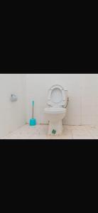 a bathroom with a toilet in a tiled room at Apartment 2 Brufut Residencies in Brufut +10 photos