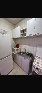 a small kitchen with a sink and a refrigerator at Apartment 2 Brufut Residencies in Brufut