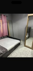 a bedroom with two beds and a mirror at Apartment 2 Brufut Residencies in Brufut