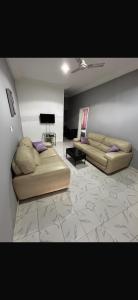 a living room with two beds and a piano at Apartment 2 Brufut Residencies in Brufut
