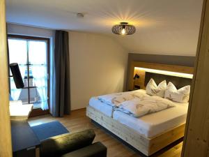 a bedroom with a bed and a large window at Schererhof in Rimsting