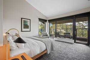 a bedroom with a large bed and a balcony at Black Rock Oceanfront Resort in Ucluelet +129 photos