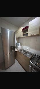 a kitchen with a stainless steel refrigerator and a sink at Apartment 3 Brufut Residencies in Brufut