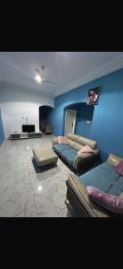 a living room with two beds and a couch at Apartment 3 Brufut Residencies in Brufut